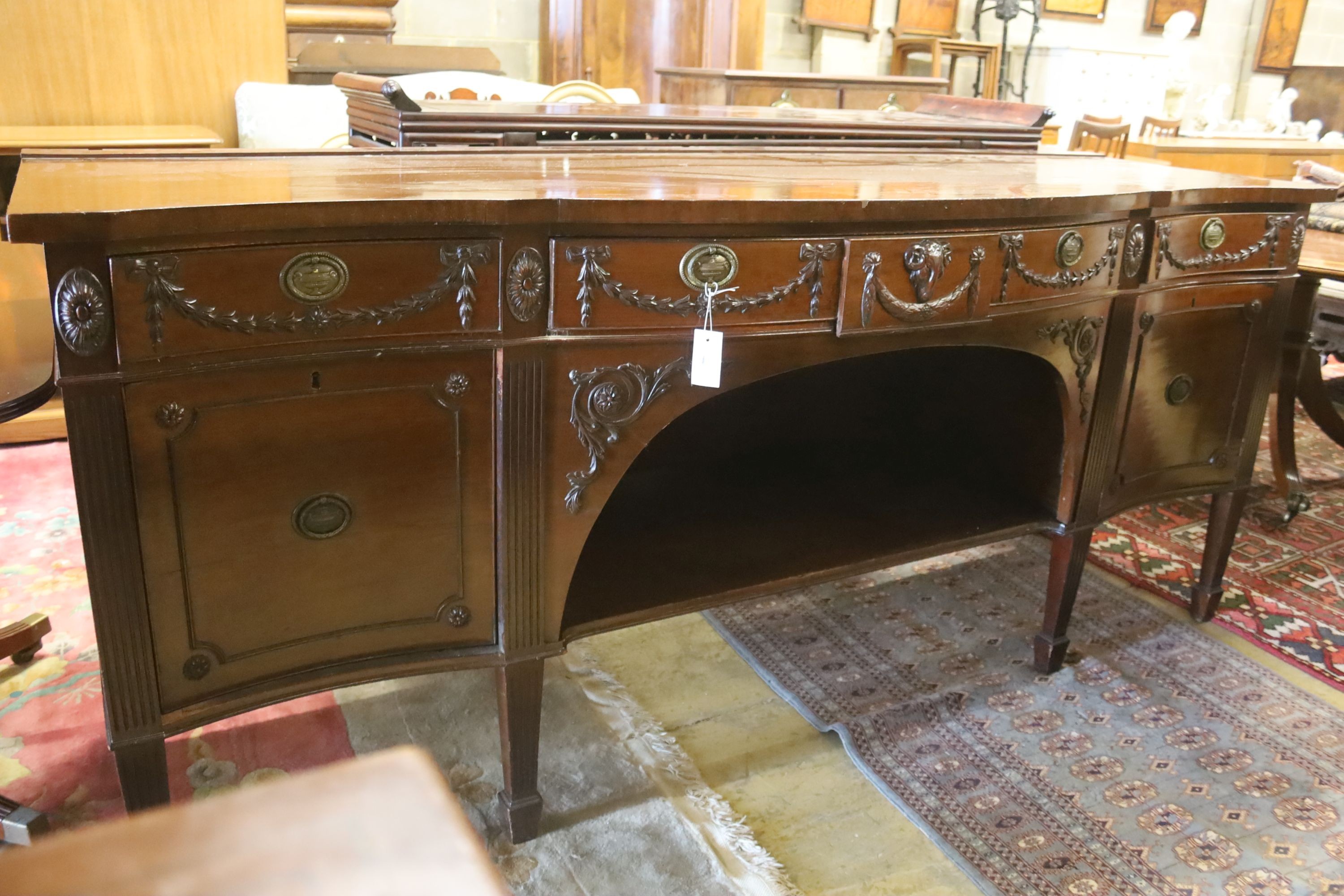 An early 20th century Adam design mahogany serpentine sideboard, length 214cm, depth 68cm, height 92cm